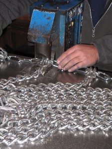 A hydraulic press makes closing the cross chain hooks much easier than using chain repair pliers. 
