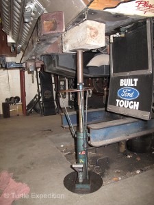 Jack stands under the rear corners of the camper allowed us to take the pressure off the giant pivot bolt in the back of the camper’s three-point suspension. 