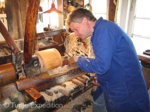 Using memory and feel, master craftsmen shape “hoops” from the carefully chosen tree trunks on a lathe.