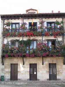 Balconies overflow with flowers.