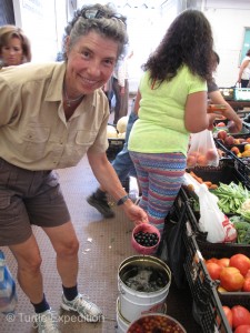 Olives from the barrel. Monika drains the juice while I snap a photo.