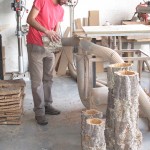 A craftsman at the Cortiçarte-Arte em Cortiça, Lda. Company hones out the center of a first-growth cork tree for use as a decorative planter or perhaps a cute lamp.