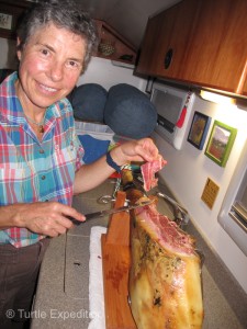 Monika is getting better at the ham-slicing stand. The thin slices melt in your mouth. If you buy a ham you can hire her. 