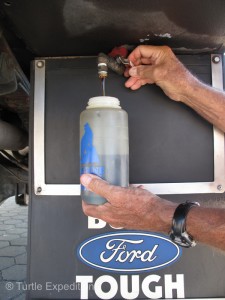 Time for a little maintenance. After just over 2,000 miles, The Turtle V had used one qt. of oil. We took a quart from our 12-gallon reservoir of Amsoil 15-40. Oil on “draft”.