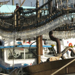 Fishing boats use strings of high-powered lights to attract squids to the surface.