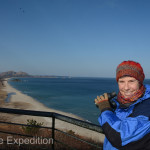 While standing on top of the Unification Observatory Monika spots a village at the base of the distant mountains. We were told that the peninsula in the middle of the bay belongs to South Korea.