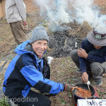 The guys sewing up rice straw invited us to sample their midday meal, delicious pork in a red pepper sauce.