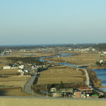 Neat rice fields spread out toward a blue East Sea (Sea of Japan) where our truck and camper would soon be sailing to California.