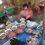 This woman was selling and eating a great selection of shucked oysters and clams along with a few skewers of abalone ready for the grill.