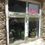 Flowers in the window showed a woman’s touch to her home.