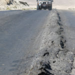 Overloaded Chinese trucks had pushed the asphalt into a 6” ridge down the middle of the highway.