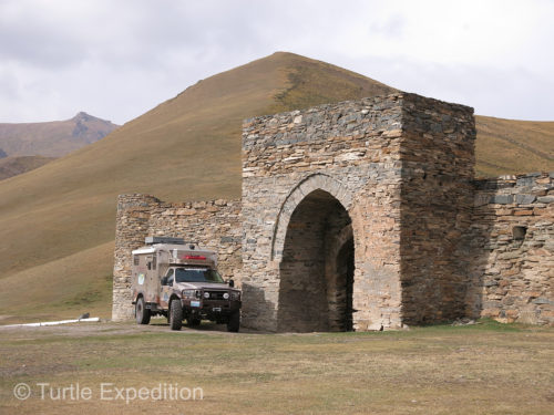 The Turtle V is parked in front of Tash Rabat, a Kyrgyz caravanserai.