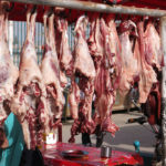 Fresh lamb and even fresher lamb at a butcher shop along side the road.