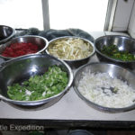 ----the second cook prepared a mixture of all kinds of vegetables and spices which he prepared in a wok.