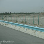 Back on the restrictive toll road, we were bordered and trapped by the steel guardrail and the nine-strand barbwire fence. We wondered, was it to keep us out or them in?