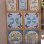 As we wandered through town under the shade of the grape trellises, we admired the are on the doors of homes.