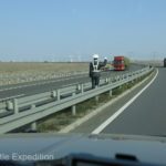 A funny fake police man kept an eye on traffic.