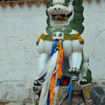 This royal lion guards the entrance of this golden pagoda.