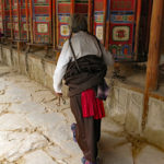 Walking along each prayer wheel gets turned.