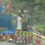 A fake policeman directing traffic.