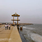 A run-down jetty stuck out into the grey water. It seemed like a tourist spot where Chinese who had maybe never seen the ocean came.