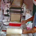 We thought this might be a way to mass-produce noodles but closer inspection showed they were making flat bread on an electric grill.