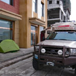 Any port in a storm. We set up Green’s MSR tent on the sidewalk using rocks instant of tent pegs.