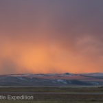 Clouds full of snow were illuminated by the rising sun.