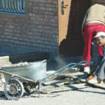 I had to smile when I saw this man cutting a board with a regular hand saw. No power tools here!