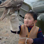 Not being an ornithologist, I could not tell if this was a hawk or maybe a young eagle being trained by this young boy for a future hunting career.