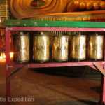 These prayer wheels were watched over by a very serious guard. The three eyes must be explained by a Buddhist expert.