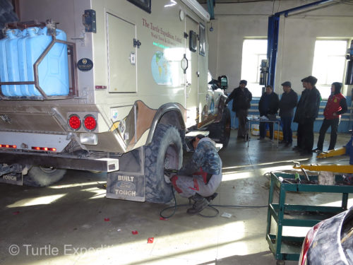 A crowd gathered to watch the mechanic go to work.