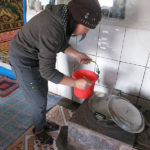 The hostess prepares hot tea with fresh milk and a pinch of salt.