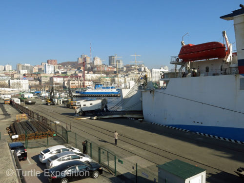 Vehicles are being loaded into the belly of the Eastern Dream DBS Cruise Ferry bound for South Korea.