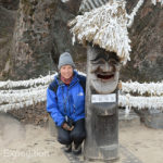 Monika poses with a carved figure in front of the 600-year old Zelkova Tree where the Goddess Samsin resides.