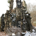 A cluster of carvings around a carefully stacked pile of rocks. It could have religious significance.