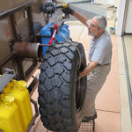 The 198-pound tire and wheel is easily lowered using a draw bar that fits a socket on the roof. A Warn Drill Winch lowers the tire to the ground