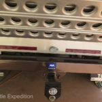 A Max Devise slides into the rear trailer hitch receiver. The Darr sand ladders store outside the big compartment in the back.