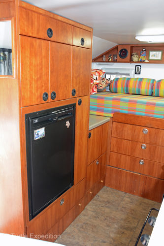Next to the entry door is the refrigerator cabinet purposely positioned over the wheel well.